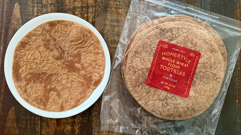 A package of Trader Joe's Homestyle Whole Wheat Flour Tortillas next to a tortilla on a plate