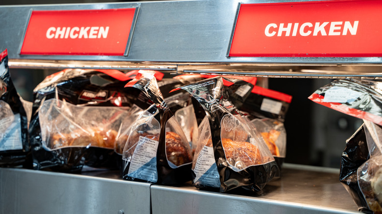 Rotisserie chickens in warmer at a grocery store