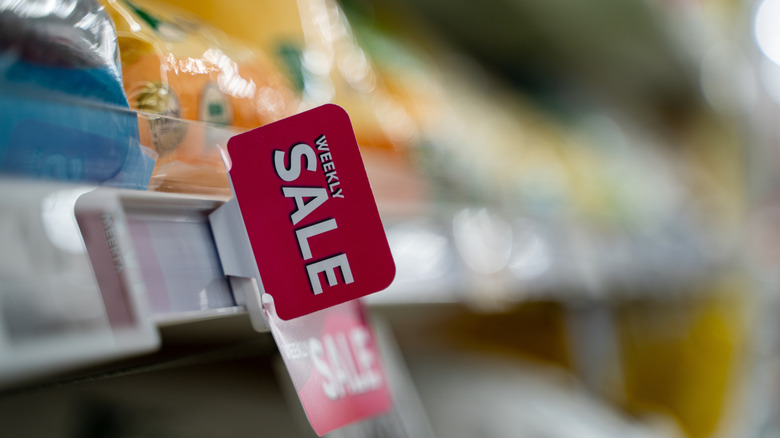 Grocery store shelf with red sale tag
