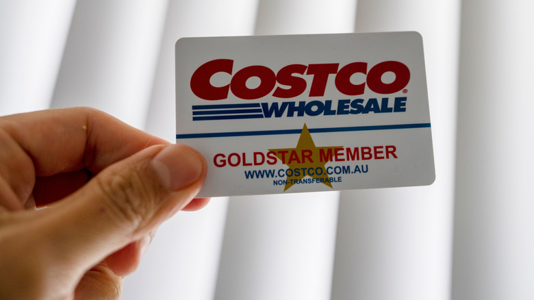 Hand holding a Costco loyalty card