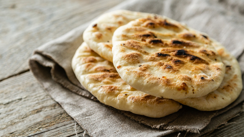 Closeup stack of pita bread on kitchen towel