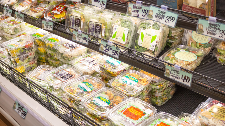 Refrigerated section at Trader Joe's with a variety of premade salads and salad kits