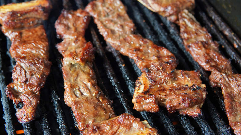 Korean style beef short ribs cooking on a grill