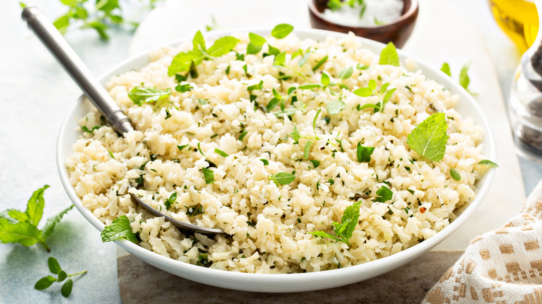 Cauliflower rice with herbs in a white bowl