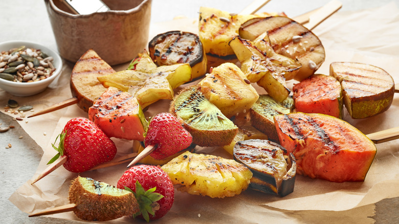 Assorted grilled fruit on wodden skewers