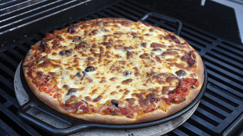 Cheese round pizza on a grill