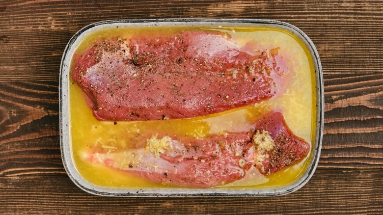 Cuts of meat in orange juice marinade