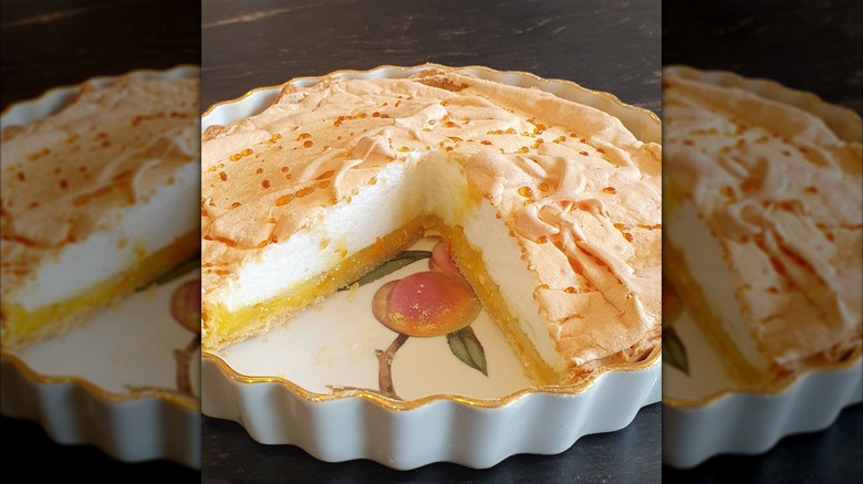 Orange meringue pie with slice taken out