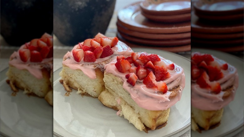 Two strawberry cinnamon rolls on plate