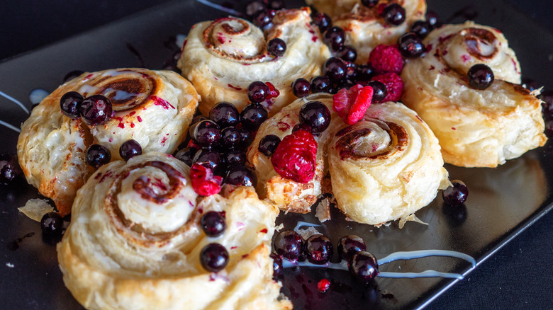 Cinnamon rolls with jam filling and fresh berries