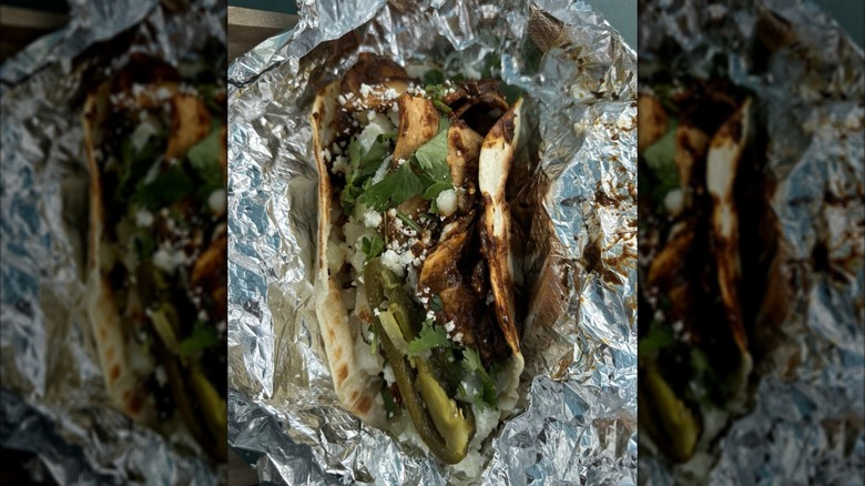 Chilaquil taco with mole in foil wrapper at Granny's Tacos in Austin