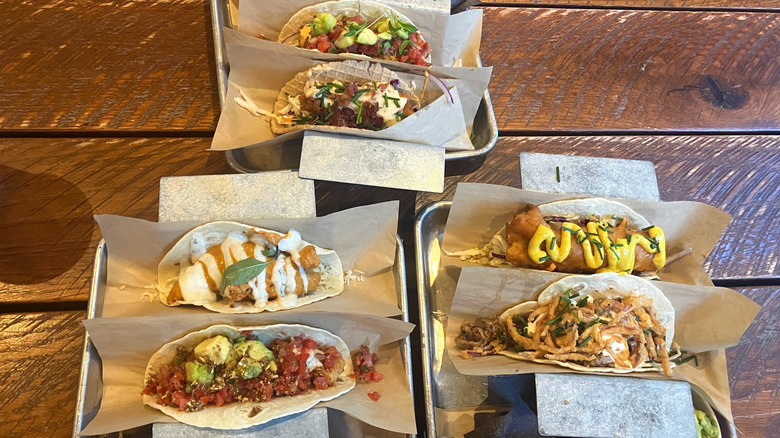 various types of tacos displayed on trays
