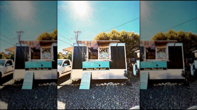 Exterior of Iolani's Plate Lunch food truck, day, mirrored