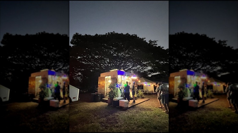 Exterior of Taco Libre food truck with customers ordering at night