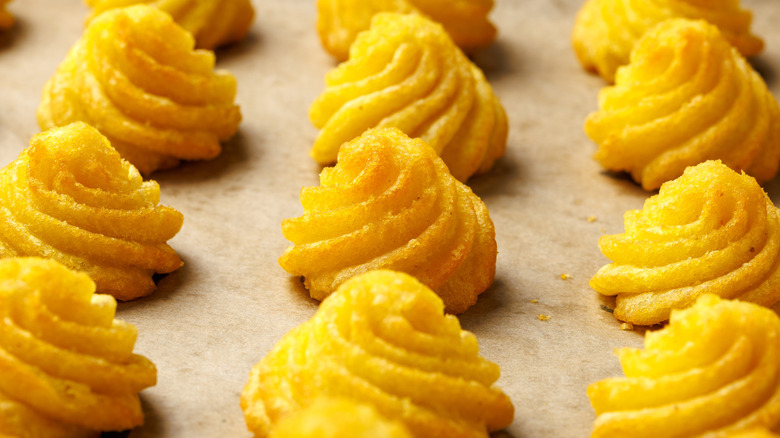 Close up of duchess potatoes on a baking sheet