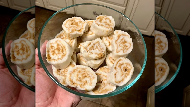 Hand holding glass bowl of potato candy