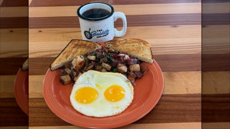 Plate with red flannel hash, toast, eggs, and coffee