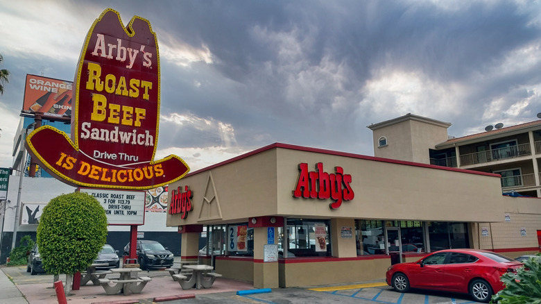 old Arby's logo in neon next to the modern logo