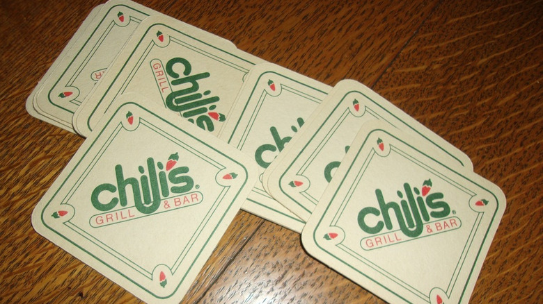 a table with vintage Chili's coasters