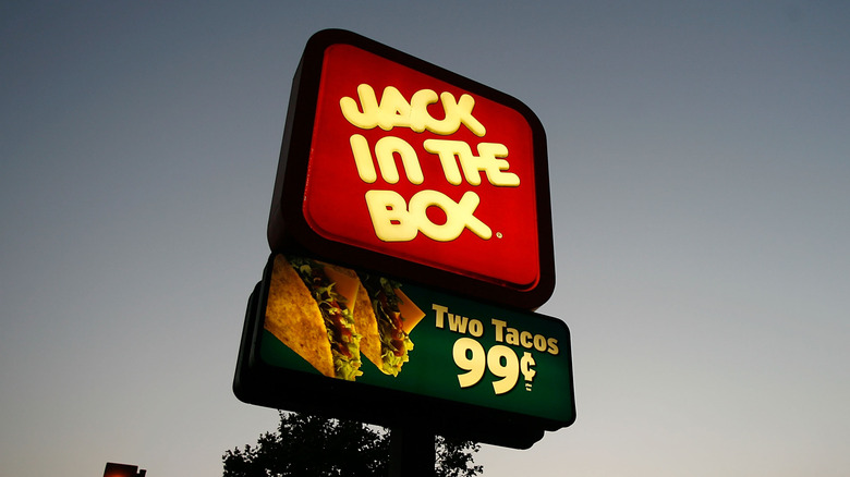 Jack In The Box sign glows in the twilight
