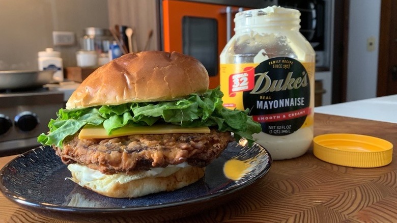 chicken fried bologna sandwich on plate with open Duke's mayo jar