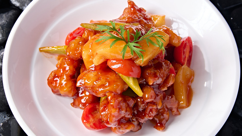 Cantonese style sweet and sour pork with pineapple in dish