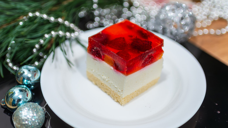 square of festive dessert on plate with layer of strawberry jello