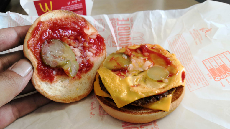 A McDonald's double cheeseburger held open