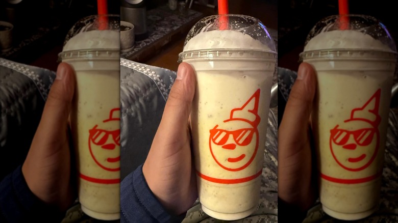 Someone holding a Jack In The Box milkshake, mirrored