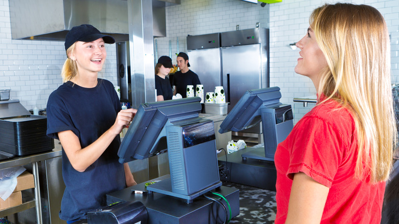 A customer ordering from a fast food restaurant