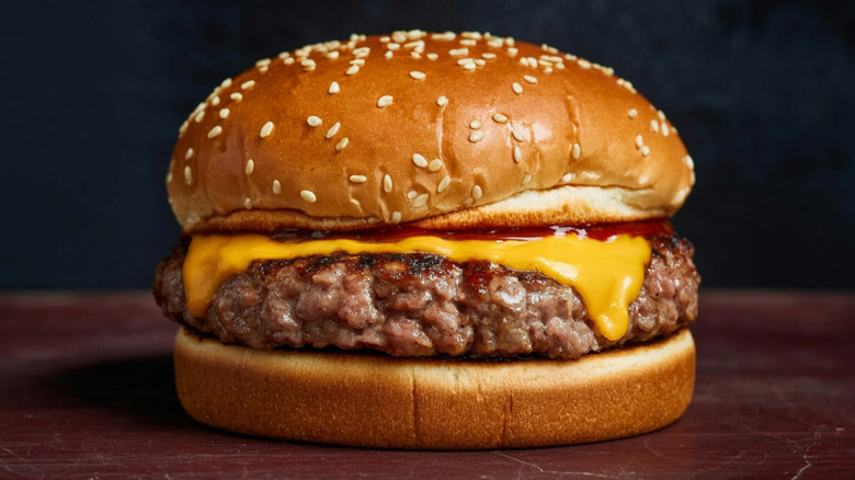 juicy cheeseburger on sesame seed bun