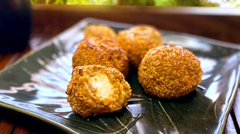 A plate of cream cheese stuffed fried plantain balls for brunch