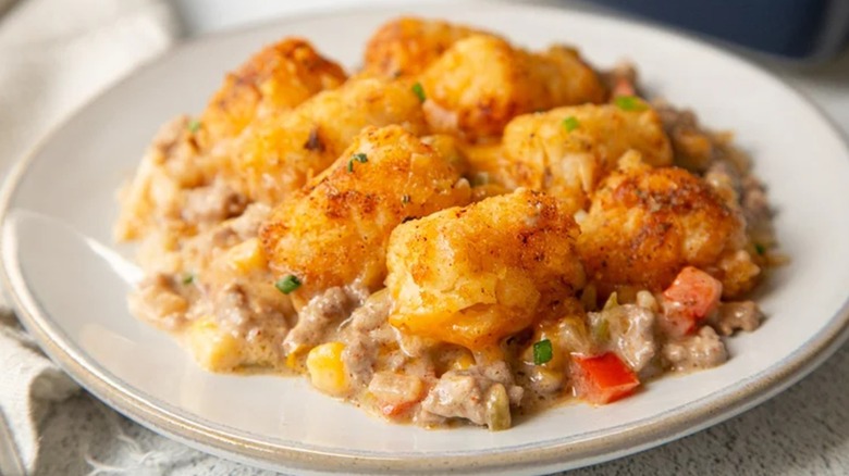 A serving of creamy, cheesy cowboy casserole on a plate