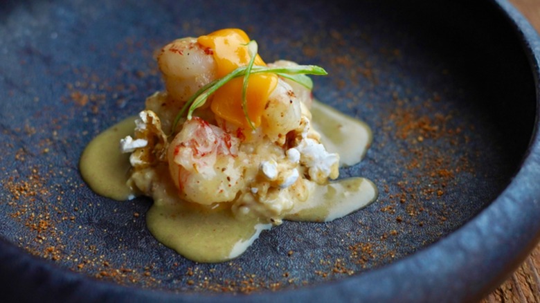 An elegant plating of shrimp and popcorn grits for brunch