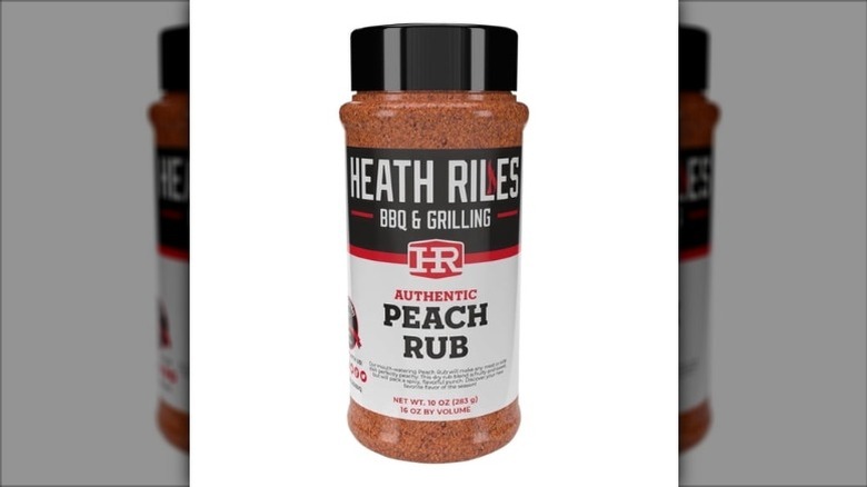 A jar of Heath Riles BBQ & Grilling Authentic Peach Rub on a white background.