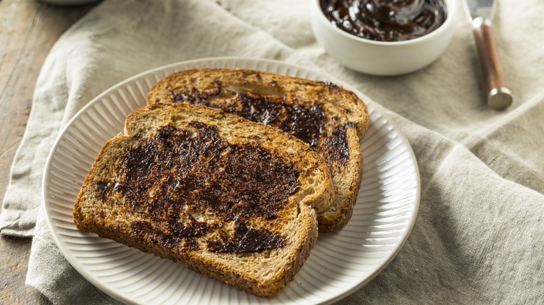 Vegemite spread on two slices of toast on a plate
