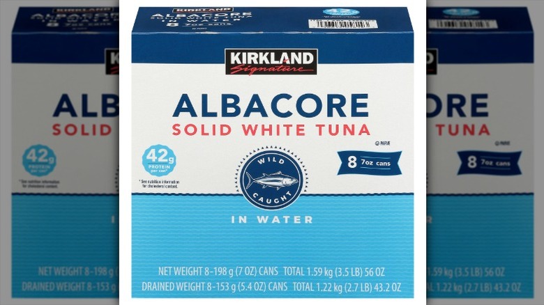 cans of Kirkland Signature Albacore Solid White Tuna in Water in a cardboard carton