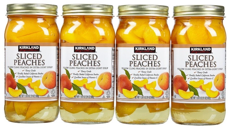 four jars of Kirkland Signature Sliced Peaches