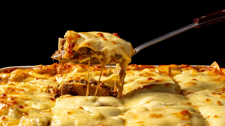 Spatula serving a piece of lasagna up from dish