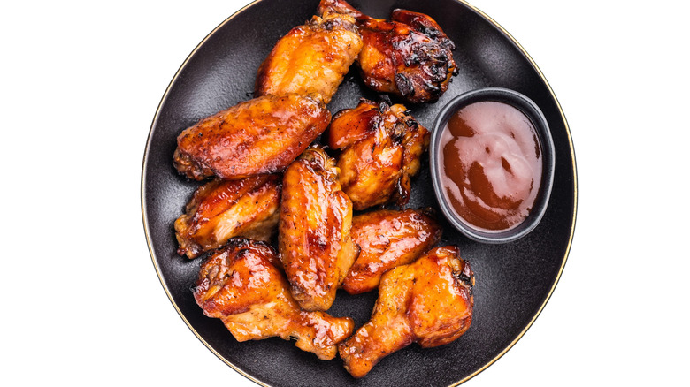 Barbecue wings on a plate with barbecue sauce