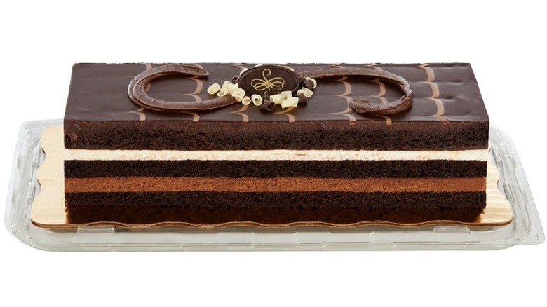 Tuxedo Bar Cake with Chocolate Mousse on a clear rectangular plastic plate on a white background.
