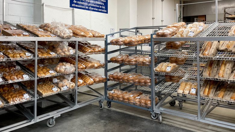 Several racks in a Sam's Club bakery full of various bread products.