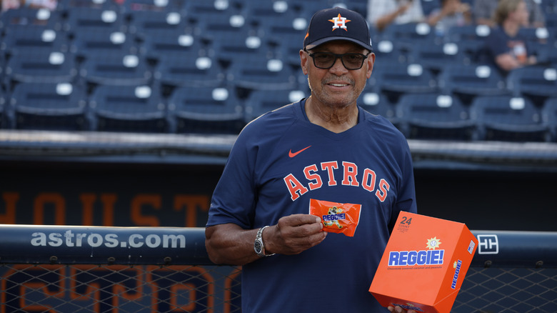 Reggie Jackson holding a Reggie! bar