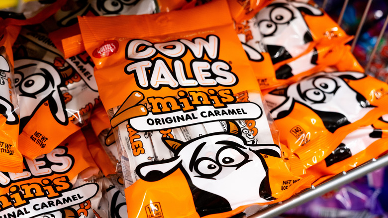 bags of Cow Tales candies on a wire rack