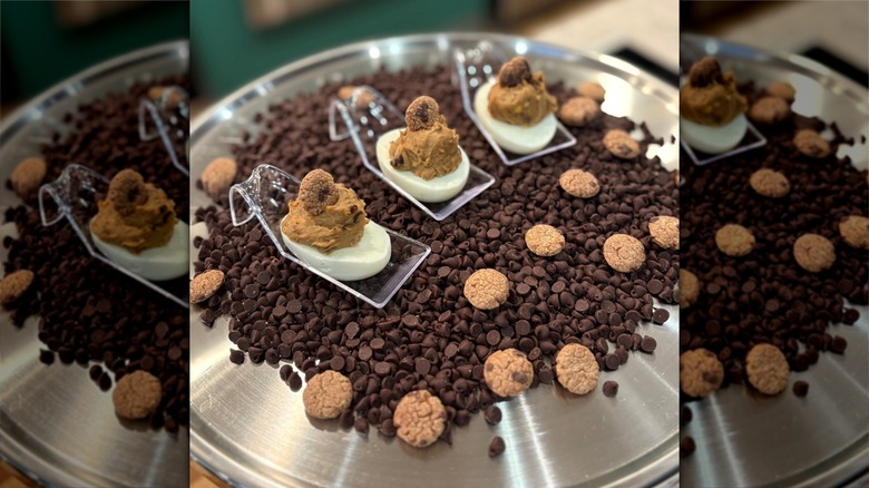 Chocolate Chip Cookie Dough Deviled Eggs atop a bed of chocolate chips