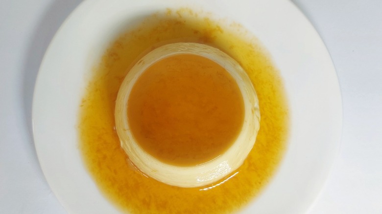 A rich Japanese purin pudding seen from above on a white plate