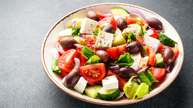 salad with greens, tomatoes, cucumbers, olives, and cheese