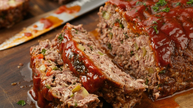 sliced meatloaf alongside a knife