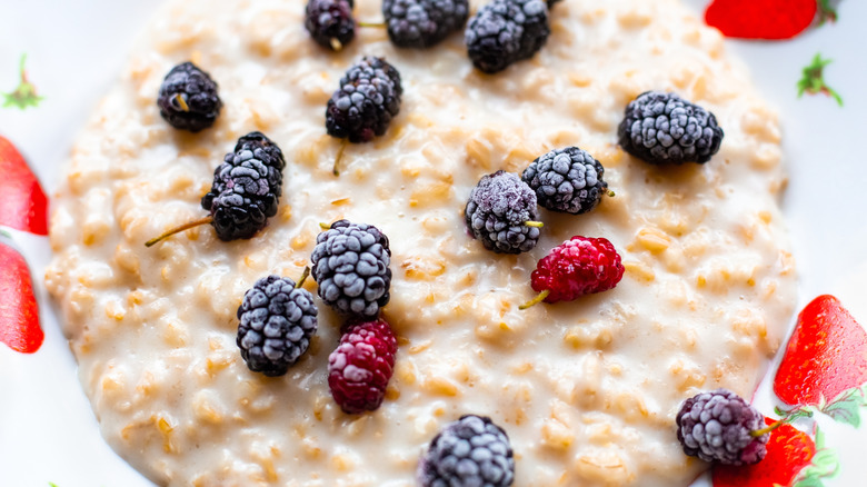 Bowl of oatmeal topped with mulberries