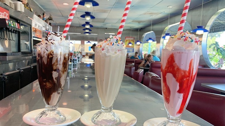 Three milkshakes in a diner